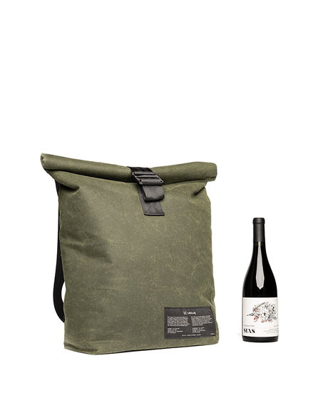 Glacière sac à dos vert kaki Lasclay à rabat enroulable, présentée à côté d'une bouteille de vin, doublure isolante à la soie d'asclépiade.